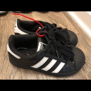 Black and white Adidas Superstars